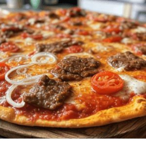 Pizza Kebab de Pizza Mania à Saint-Yrieix-la-Perche avec viande kebab, tomates, oignons, fromage et sauce kebab.