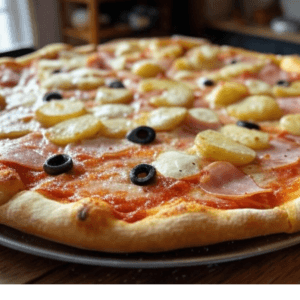 Pizza Maroilles de Pizza Mania à Saint-Yrieix-la-Perche avec maroilles, pommes de terre, jambon, crème fraîche, olives et fromage fondant.