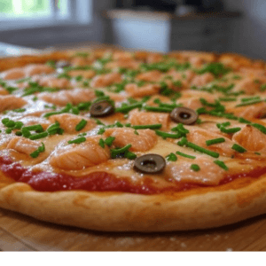 Pizza Saumon de Pizza Mania à Saint-Yrieix-la-Perche avec saumon, ciboulette, crème fraîche, olives et fromage fondant.
