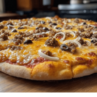 La Burger chez Pizza Mania à Saint-Yrieix-la-Perche - une pizza savoureuse avec viande de bœuf, cheddar et base barbecue.